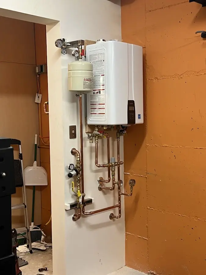 Plumbing technician inspecting water heater connections in Moncks Corner